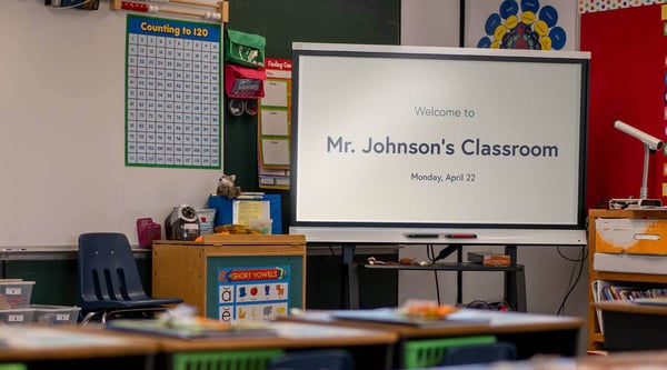 Digital signage on a screen in an empty classroom