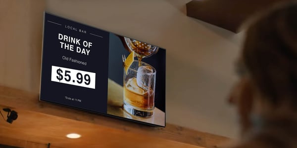 Digital signage showing drink specials in a bar