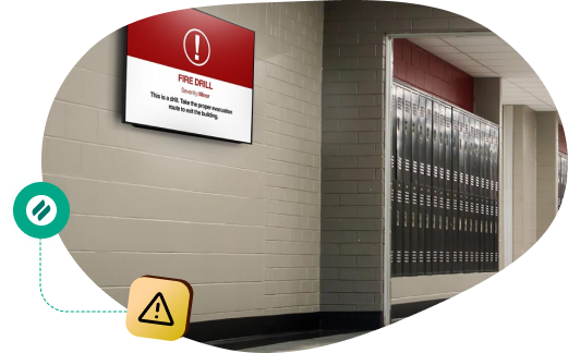 A school hallway with lockers and a digital screen displaying a fire drill alert. The Ditto logo and a warning icon indicate an alert system connection.