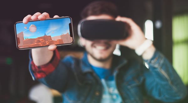 Man holding phone and VR headset