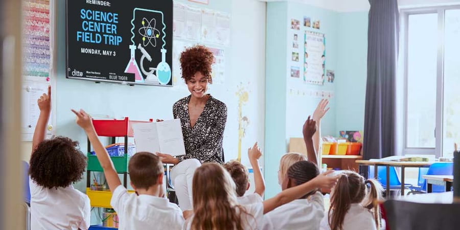 Classroom with digital signage announcing a field trip