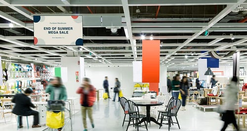 Digital signage promoting a sale in a store with customers